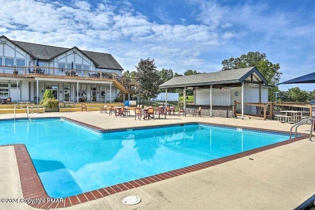 community pool with a patio and fence