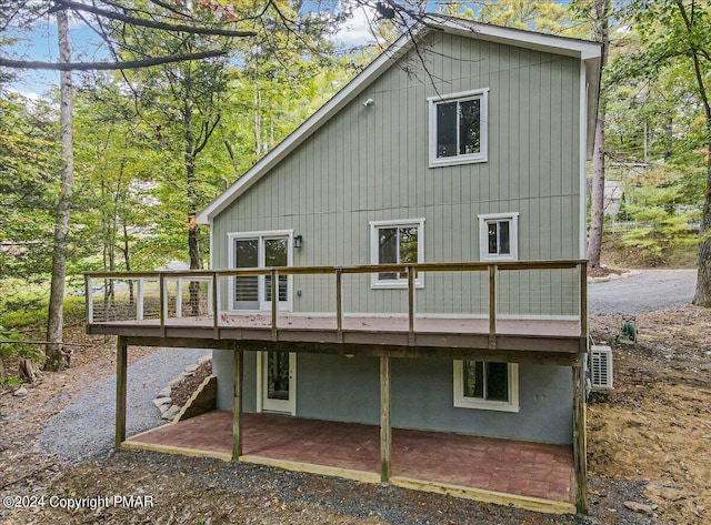 back of house with a patio area and a deck