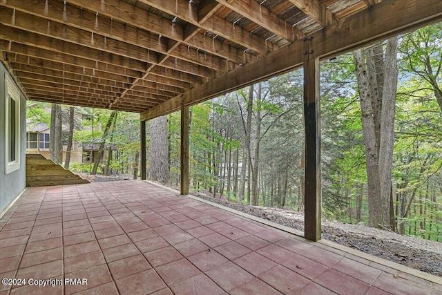 view of patio / terrace featuring a wooded view