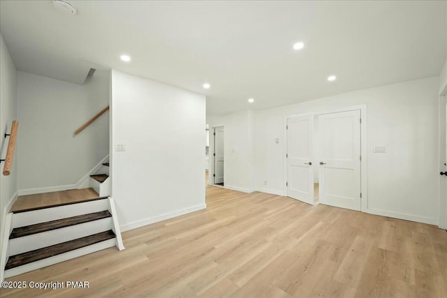 basement with light hardwood / wood-style floors