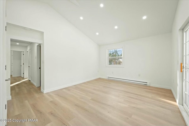 unfurnished room with lofted ceiling, baseboard heating, and light hardwood / wood-style flooring