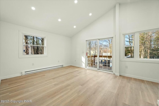 interior space featuring a baseboard heating unit, light hardwood / wood-style flooring, and high vaulted ceiling