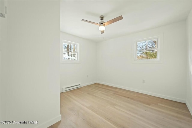 unfurnished room with a baseboard radiator, ceiling fan, and light hardwood / wood-style floors