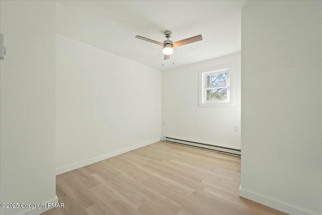 unfurnished room with baseboard heating, ceiling fan, and light hardwood / wood-style floors