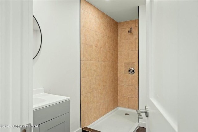 bathroom featuring vanity and a tile shower