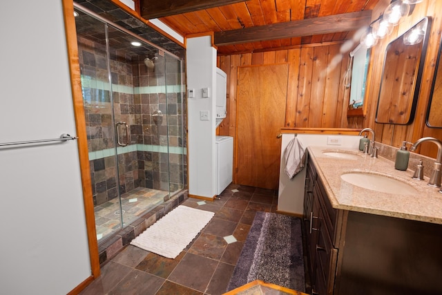 2107 Oak Rd, Pocono Pines, PA 18350 - bathroom with double vanity, wood ceiling with exposed beams, a shower stall, stacked washer / dryer, and wood walls