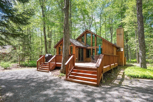 2107 Oak Rd, Pocono Pines, PA 18350 - rear view of property with a chimney, a deck, and a view of trees
