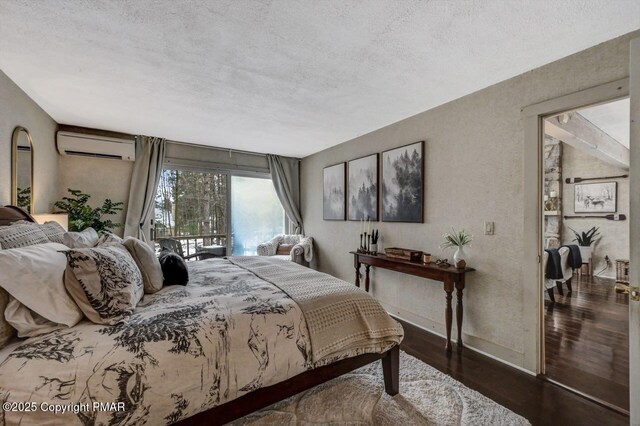 bedroom with dark wood-type flooring, a wall mounted AC, and a textured ceiling