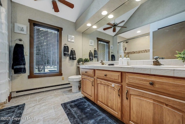 bathroom with toilet, vaulted ceiling, vanity, ceiling fan, and a baseboard heating unit