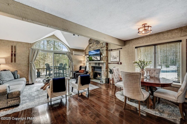 living room featuring dark wood-type flooring, a stone fireplace, a textured ceiling, and vaulted ceiling with beams