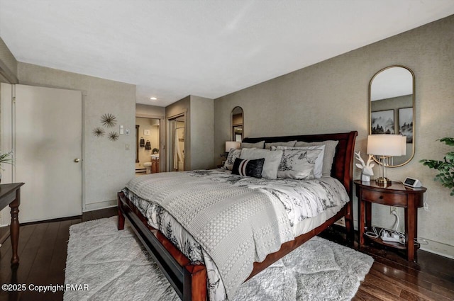 bedroom with dark wood-type flooring and a closet