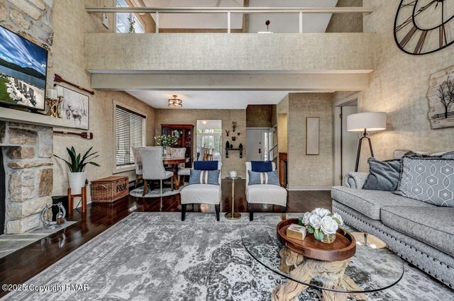 living room featuring a towering ceiling and wood-type flooring