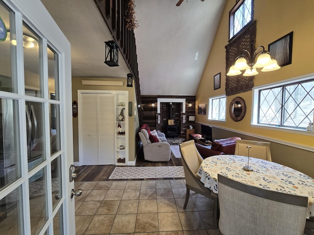 176 Fawn Rd, Pocono Lake, PA 18347 - dining room with tile patterned floors, a towering ceiling, and an inviting chandelier