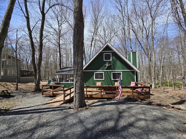 176 Fawn Rd, Pocono Lake, PA 18347 - view of front facade featuring a wooden deck and a chimney