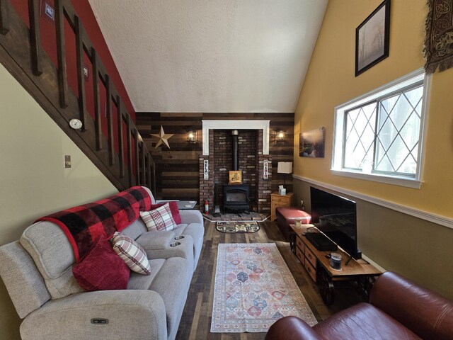 176 Fawn Rd, Pocono Lake, PA 18347 - living area with wood finished floors, a wood stove, high vaulted ceiling, and stairway