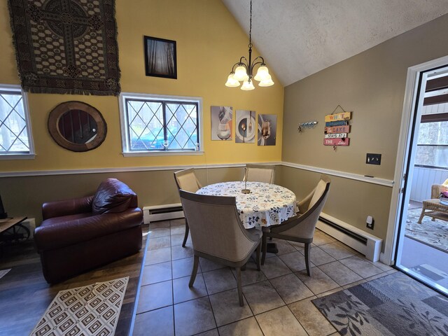 176 Fawn Rd, Pocono Lake, PA 18347 - dining room with a baseboard radiator, baseboards, high vaulted ceiling, and an inviting chandelier