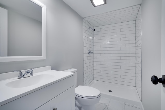 bathroom with a shower stall, vanity, toilet, and marble finish floor