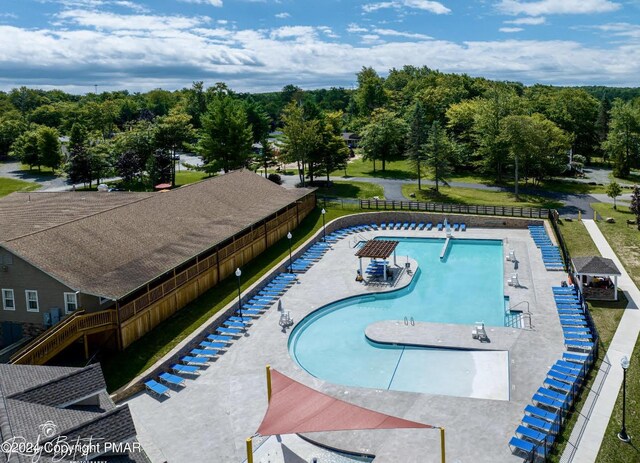 pool with fence and a patio area