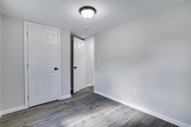 unfurnished bedroom featuring baseboards and wood finished floors