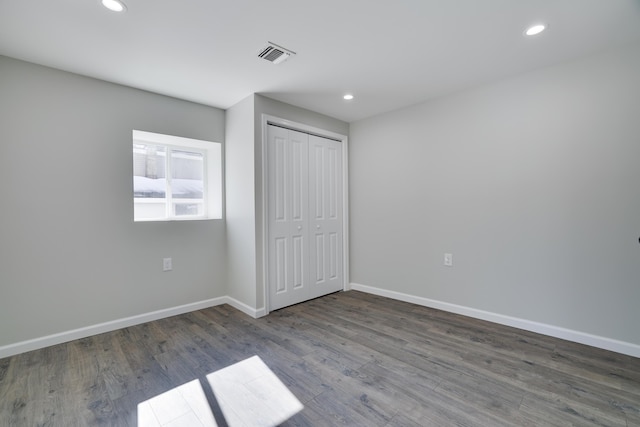 unfurnished bedroom with recessed lighting, visible vents, baseboards, and wood finished floors