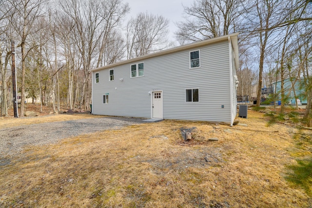 rear view of property featuring central AC unit