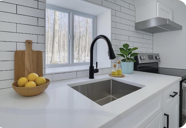 8263 Natures Dr, Tobyhanna, PA 18466 - kitchen view of a sink, stainless steel electric stove, white cabinets, and light countertops