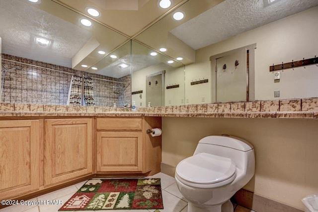 bathroom featuring recessed lighting, toilet, a textured ceiling, tile patterned flooring, and tiled shower