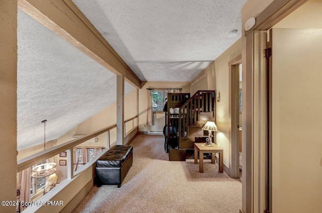 sitting room featuring a chandelier, carpet, beam ceiling, and a textured ceiling