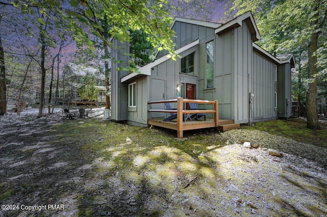 rear view of property featuring board and batten siding