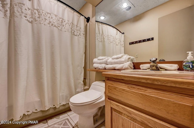 full bath featuring toilet, tile patterned flooring, shower / bath combo with shower curtain, a textured ceiling, and vanity