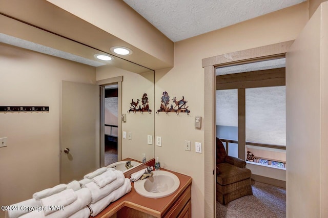 bathroom featuring recessed lighting, a textured ceiling, and vanity