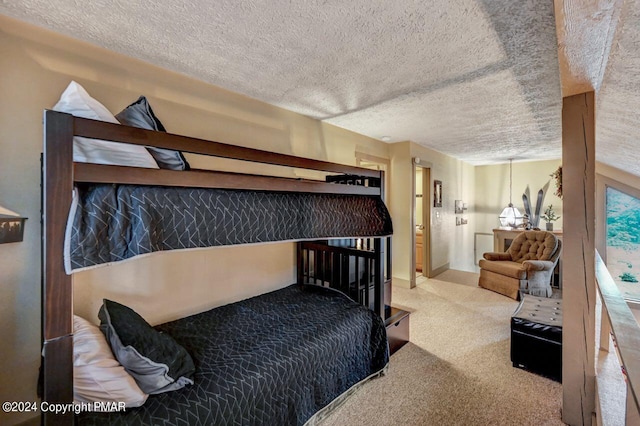 bedroom with a textured ceiling and carpet flooring