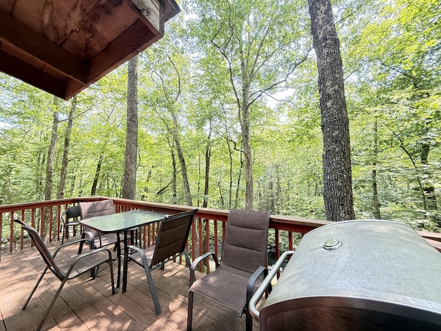 6414 Decker Rd, Bushkill, PA 18324 - wooden terrace featuring outdoor dining area, grilling area, and a view of trees