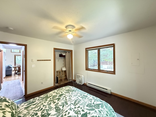 6414 Decker Rd, Bushkill, PA 18324 - bedroom featuring a baseboard radiator, dark wood finished floors, a closet, electric panel, and ceiling fan