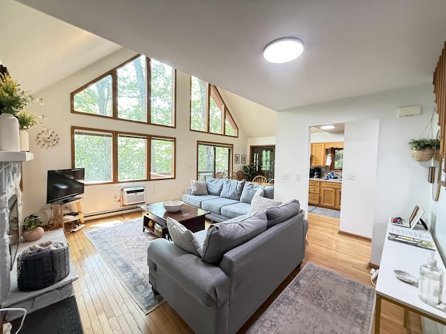 6414 Decker Rd, Bushkill, PA 18324 - living room with lofted ceiling, plenty of natural light, light wood-type flooring, and a fireplace