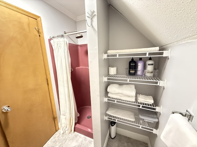6414 Decker Rd, Bushkill, PA 18324 - bathroom with a stall shower, a textured ceiling, crown molding, and lofted ceiling