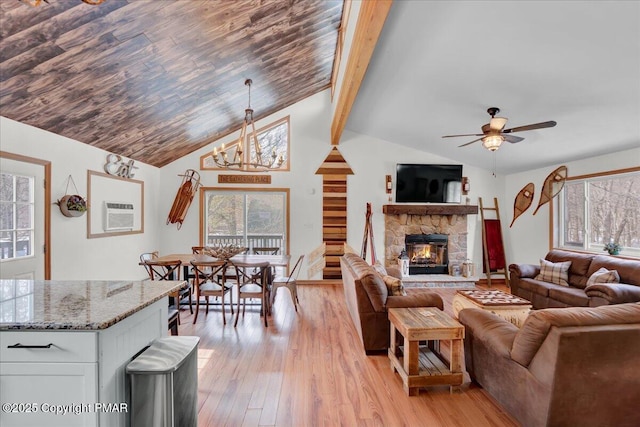 living room featuring light wood finished floors, plenty of natural light, and a wall mounted AC