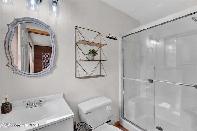 full bath with vanity, toilet, and a stall shower