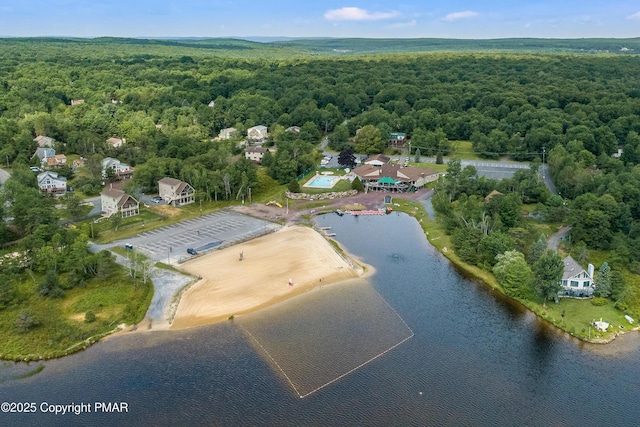 bird's eye view with a view of trees and a water view