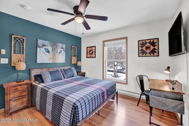 bedroom with light wood-style flooring and a ceiling fan