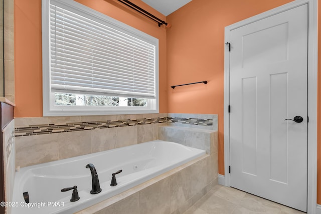 bathroom with a garden tub and tile patterned floors