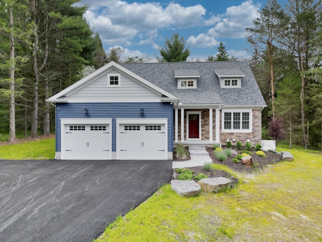 210 Canterbury Cir, Blakeslee, PA 18610 - view of front of property featuring driveway, stone siding, an attached garage, a front yard, and roof with shingles