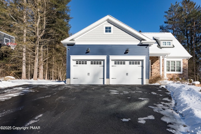 view of front of property featuring an attached garage and driveway