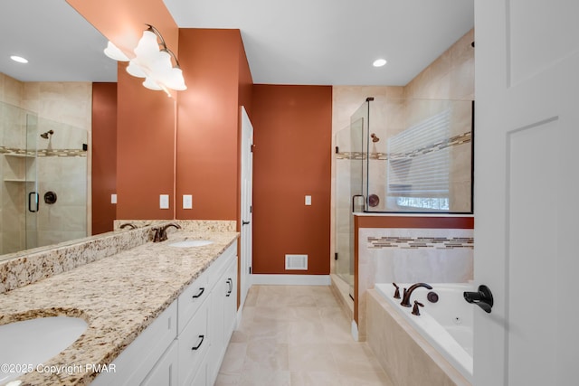 bathroom featuring a stall shower, visible vents, a whirlpool tub, and double vanity