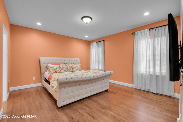 bedroom with light wood-type flooring, baseboards, and recessed lighting