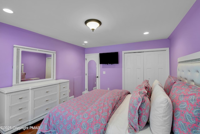 bedroom with recessed lighting, a closet, and dark wood-style flooring