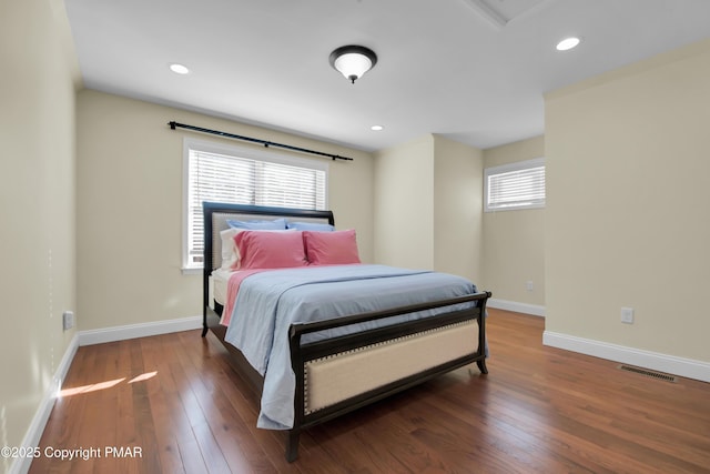 bedroom featuring hardwood / wood-style flooring, recessed lighting, visible vents, and baseboards