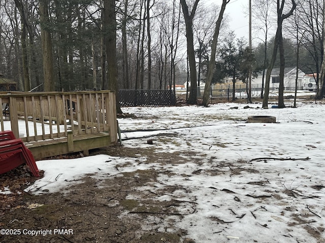 yard layered in snow with a deck