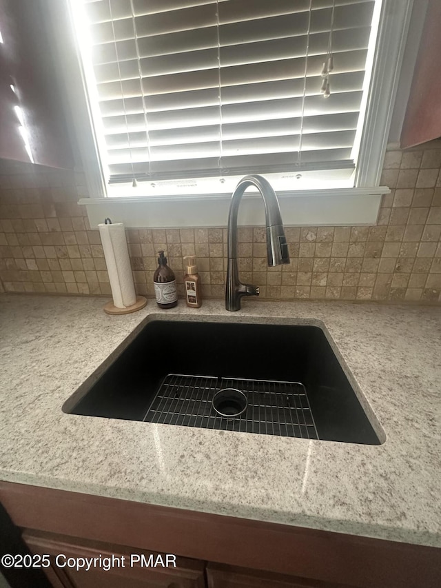 interior details with sink and decorative backsplash