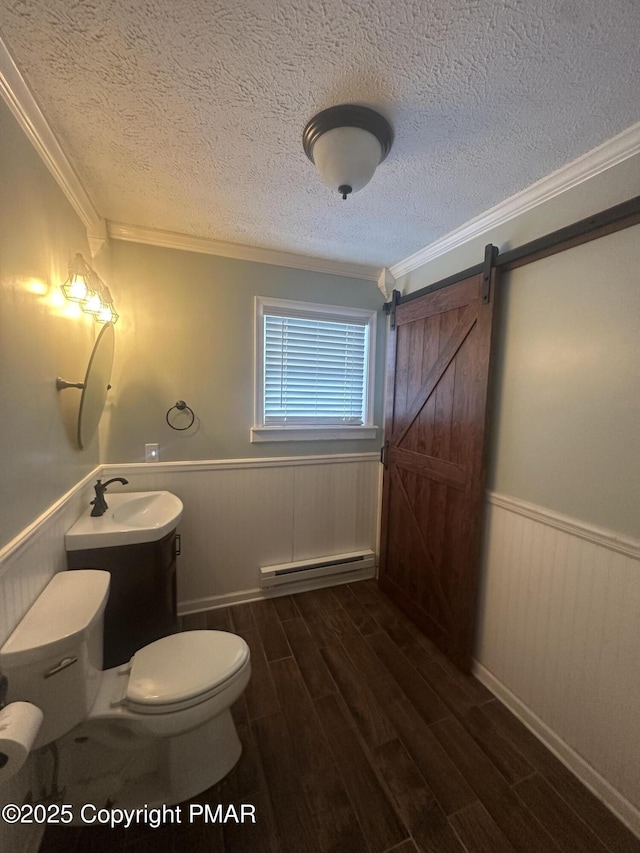 bathroom with baseboard heating, crown molding, and a textured ceiling